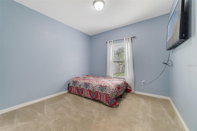 bedroom with carpet and baseboards