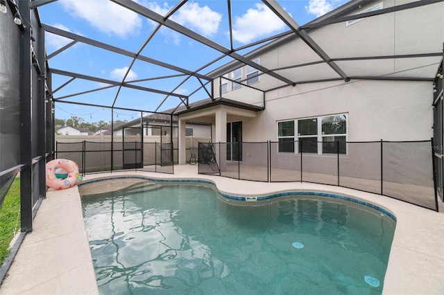 view of pool featuring a patio area, fence, glass enclosure, and a fenced in pool