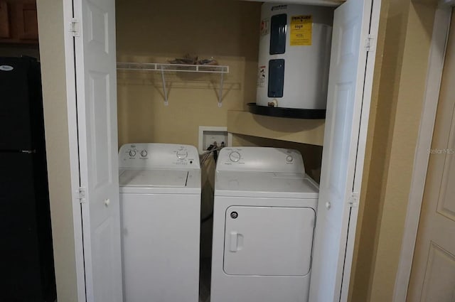 laundry room with separate washer and dryer and water heater