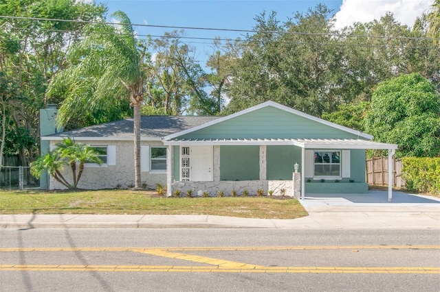 ranch-style home with a front yard and a porch