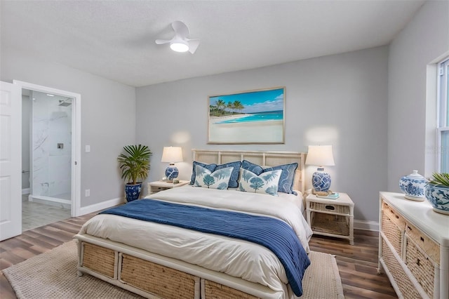 bedroom featuring dark hardwood / wood-style flooring, ensuite bath, and ceiling fan