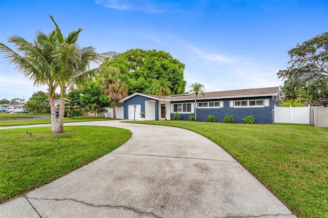 single story home featuring a front lawn