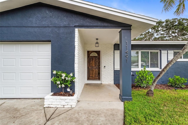 view of exterior entry with a garage