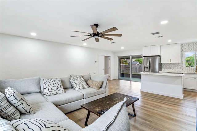 living room featuring light wood-type flooring and ceiling fan