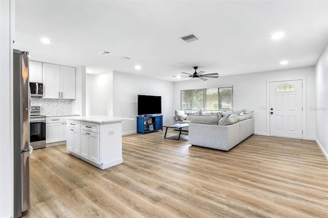 living room with ceiling fan and light wood-type flooring