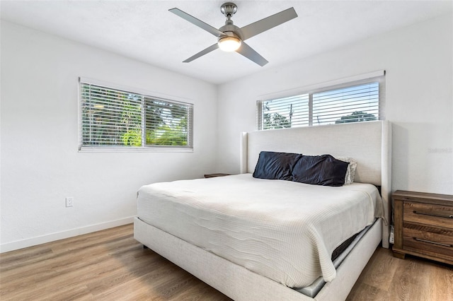 bedroom with hardwood / wood-style flooring and ceiling fan