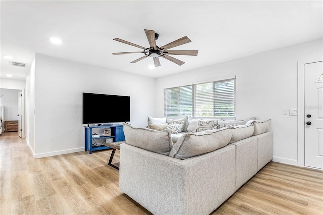 living room with ceiling fan and wood-type flooring