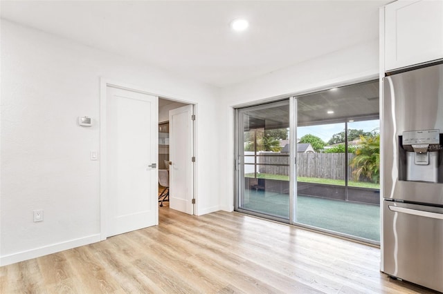 spare room with light wood-type flooring