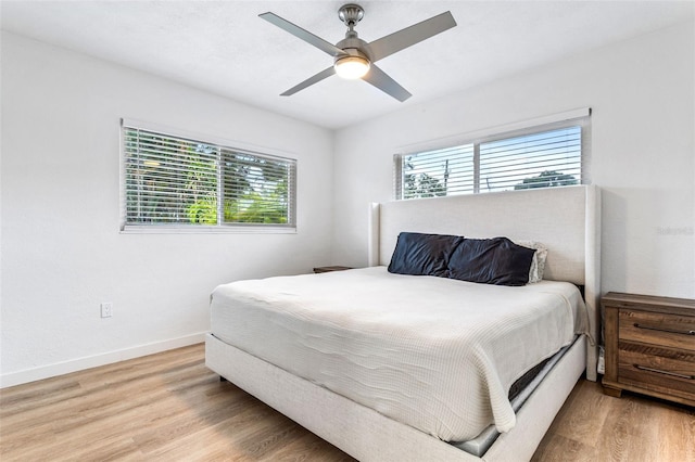 bedroom with light hardwood / wood-style floors and ceiling fan