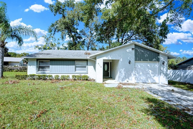 ranch-style house featuring a front lawn and a garage