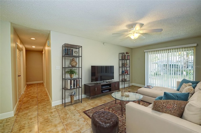 tiled living room featuring ceiling fan and a textured ceiling