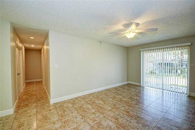 tiled empty room featuring ceiling fan and a textured ceiling