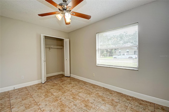 unfurnished bedroom with a textured ceiling, a closet, ceiling fan, and light tile patterned flooring