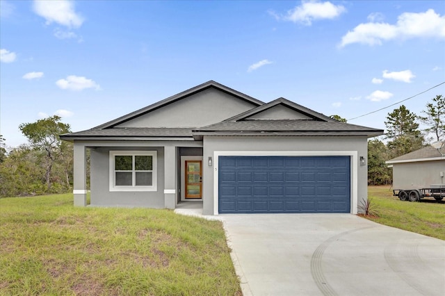 view of front of home featuring a front lawn and a garage