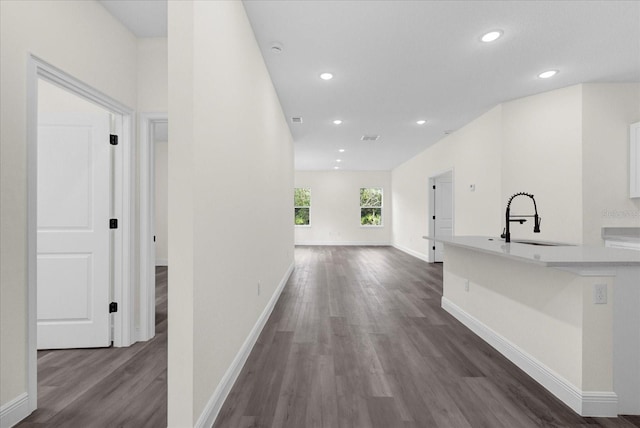 hall with sink and dark hardwood / wood-style flooring