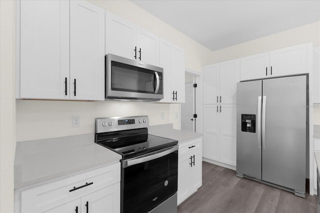 kitchen featuring white cabinets, light hardwood / wood-style floors, and appliances with stainless steel finishes