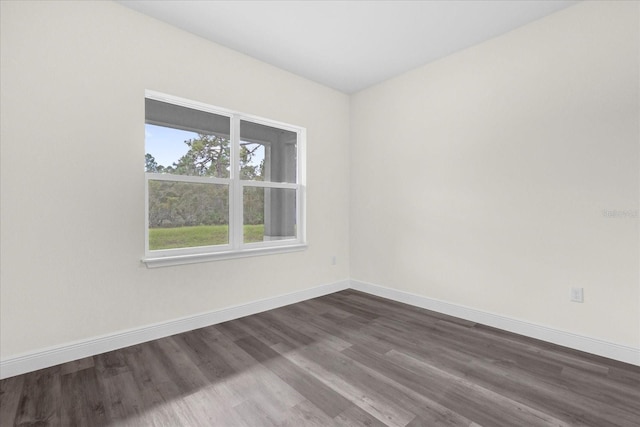 unfurnished room with dark hardwood / wood-style floors