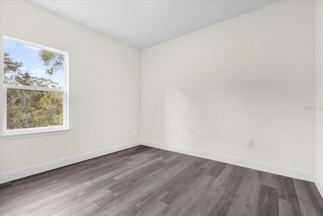 empty room with dark wood-type flooring