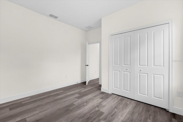 unfurnished bedroom featuring light hardwood / wood-style floors and a closet