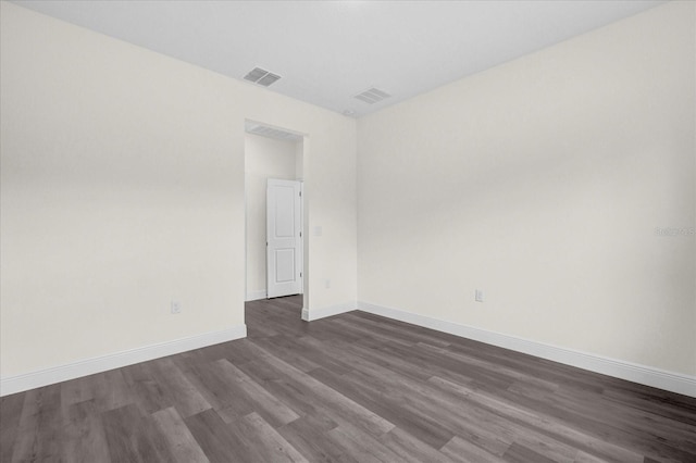 unfurnished room with dark hardwood / wood-style flooring