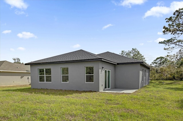 rear view of house with a yard