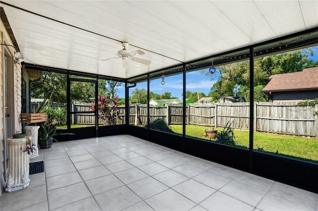 unfurnished sunroom featuring ceiling fan