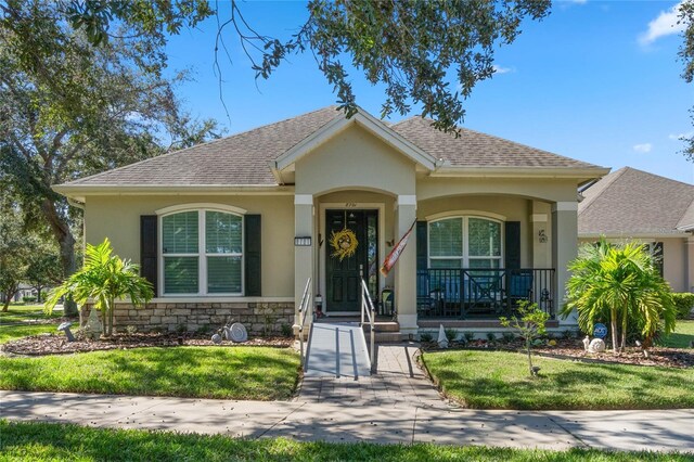 view of front of property with a front yard and covered porch