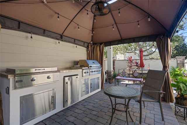 view of patio / terrace with area for grilling, a gazebo, and an outdoor kitchen