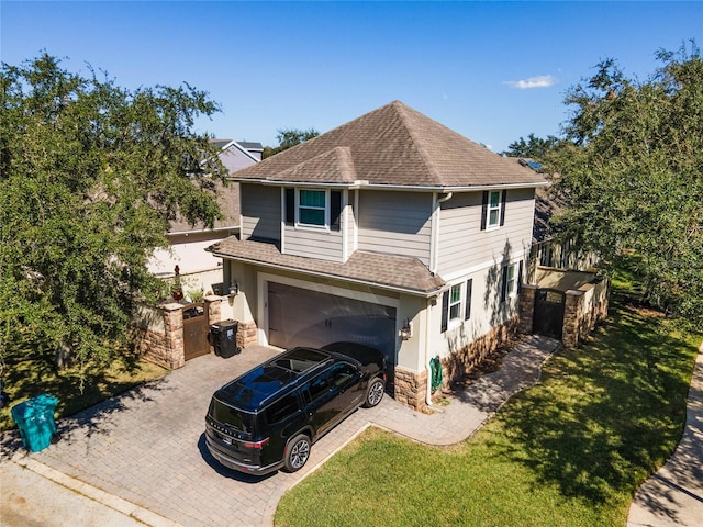 view of front facade featuring a front lawn and a garage