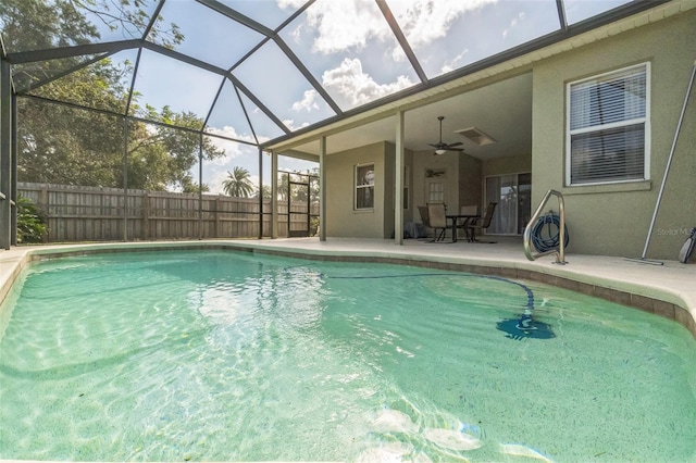 view of pool featuring a patio, ceiling fan, and a lanai