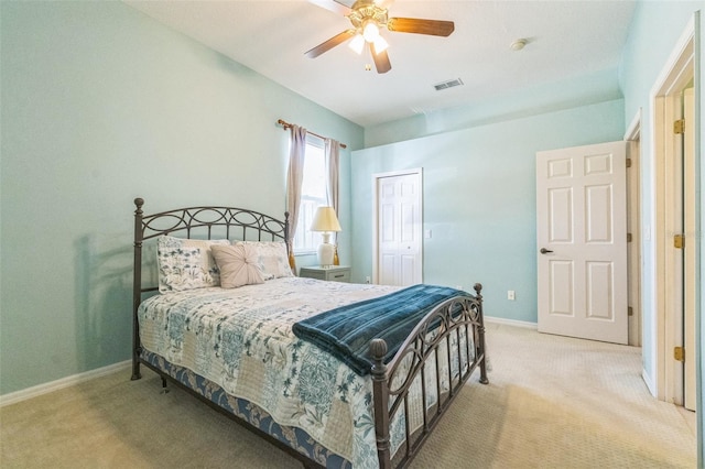 bedroom featuring ceiling fan, light colored carpet, and a closet