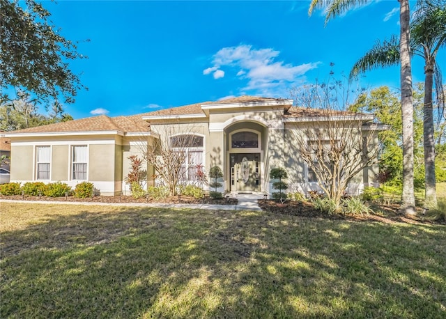 mediterranean / spanish-style house featuring a front lawn