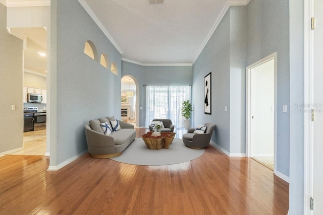 living room featuring wood-type flooring and ornamental molding