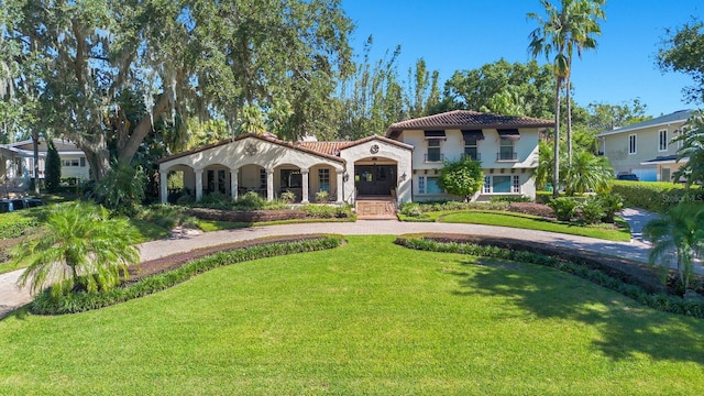 mediterranean / spanish-style house featuring a front yard