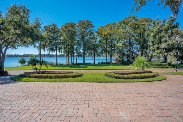 view of home's community featuring a yard and a water view