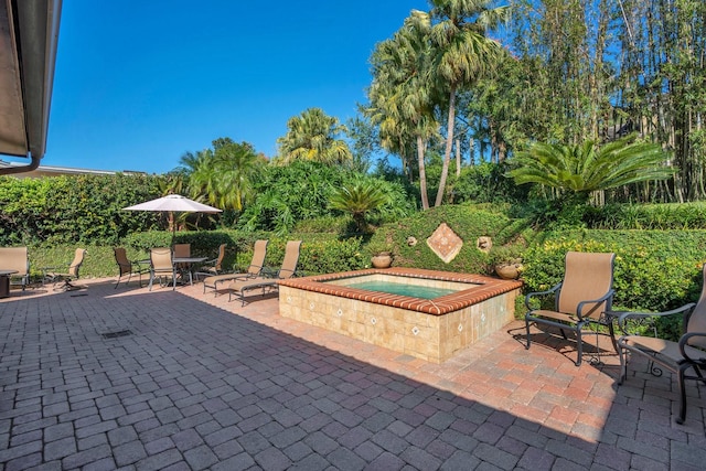 view of patio featuring an in ground hot tub