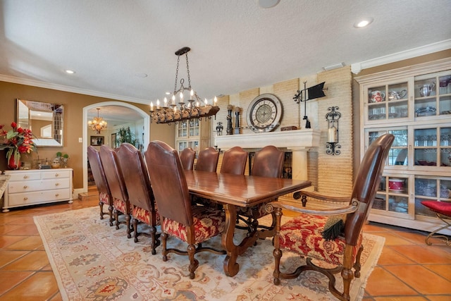 tiled dining space featuring crown molding, a textured ceiling, an inviting chandelier, and plenty of natural light