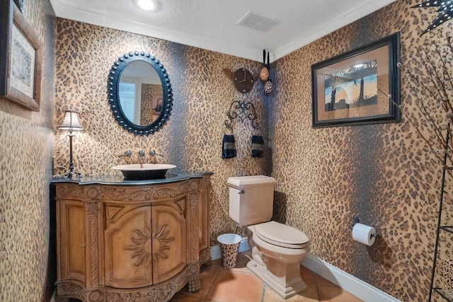 bathroom featuring vanity, toilet, tile patterned floors, and ornamental molding