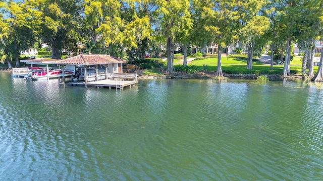 view of dock featuring a yard and a water view