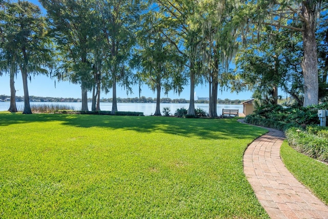 view of home's community featuring a yard and a water view