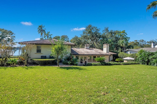 back of property featuring a yard