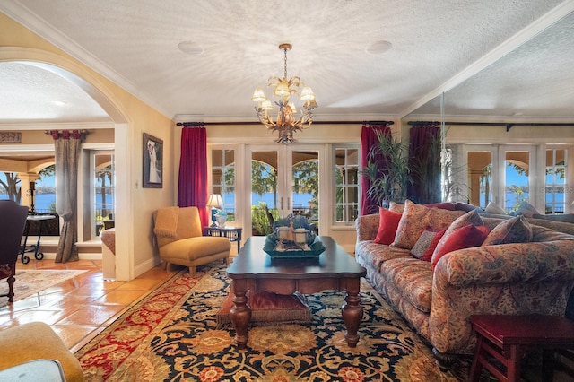 tiled living room featuring french doors, crown molding, a textured ceiling, and a chandelier