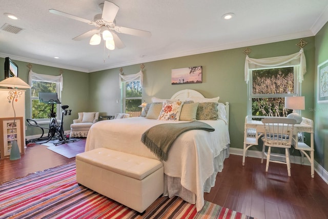 bedroom featuring ceiling fan, ornamental molding, and dark hardwood / wood-style floors