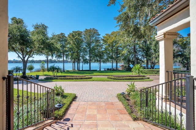 view of property's community featuring a water view and a lawn