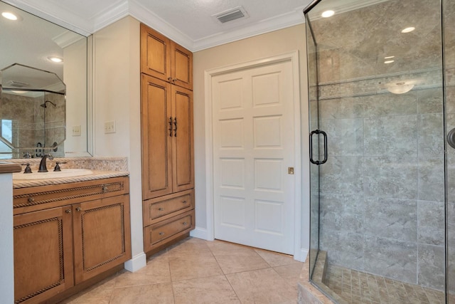 bathroom with vanity, ornamental molding, walk in shower, and tile patterned flooring