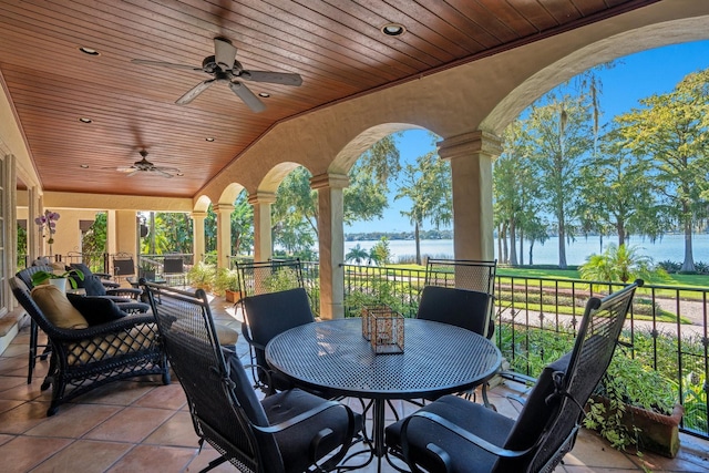 view of patio / terrace with a water view and ceiling fan