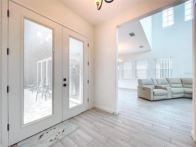 doorway featuring french doors, light hardwood / wood-style flooring, and a wealth of natural light