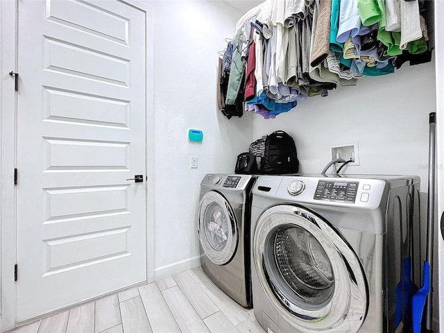 clothes washing area featuring light hardwood / wood-style flooring and independent washer and dryer