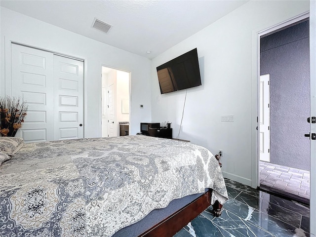 bedroom featuring connected bathroom and a closet