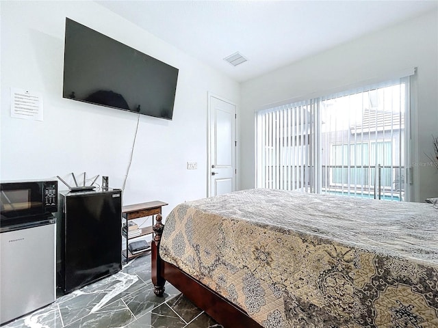 bedroom with fridge and stainless steel refrigerator